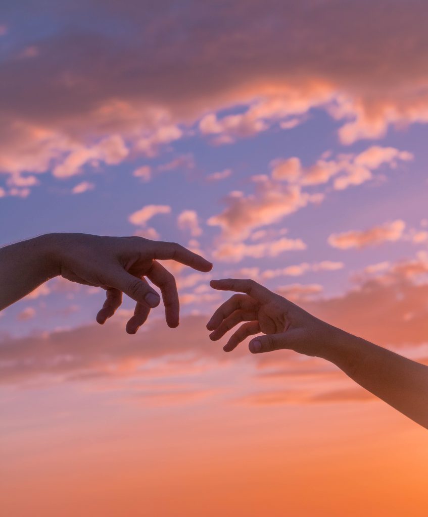 sunset with 2 hands almost touching